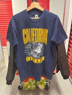 "Vintage 90s California University Football Large Graphic T-shirt Size Large USA In good condition. Please study the pictures provided so that you may judge the condition of the t-shirt. This t-shirt is a size Large. Made in the USA.  Measures approximately 21\" inches in width and 28.5\" inches in length. All Sales Are Final! Feel free to message us with any questions or concerns. Thank You!" 90s California, California University, College T Shirts, University Of California, Vintage 90s, Style Me, Graphic T Shirt, Graphic Tshirt, University