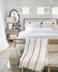 a white bed sitting in a bedroom on top of a rug