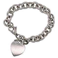 A fine Tiffany & Co. sterling silver bracelet. With slightly oval links and a heart-shaped pendant charm. The charm is not engraved. Great Tiffany design! Date: 20th Century Overall Condition: It is in overall good, as-pictured, used estate condition with some very fine & light surface scratches and other signs of expected light wear consistent with age. Fineness: Marked 925 for sterling silver fineness. Marks: Tiffany & Co. / 925 Measurements: Length: ca. 7 1/4 in. (or ca. 190 mm) Width: ca. 10 Dog Chain, Fashion Journal, Starfish Bracelet, Silver Dog, Bracelet Heart, Tiffany Jewelry, Metal Chain Link, Tiffany And Co, Sterling Silver Bracelet