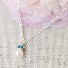 A beautiful freshwater pearl is topped with a shiny sterling silver daisy and a faceted genuine birthstone gemstone, making it extra personal. How sweet would this be for her birthday? Gorgeous hand-chosen AAA grade centerpiece pearl is approximately 7mm and is topped with a 3.5mm(ish) genuine gemstone. So pretty! Delicate Sterling Silver Birthstone Necklace For May, Dainty Sterling Silver Birthday Birthstone Necklace, Gift Pearl Necklace With Gemstone, Pearl White Gemstone Pearl Necklace Gift, Elegant Birthstone Necklace For Birthday Gift, Delicate Pearl Necklace With Gemstone For Gift, Delicate Sterling Silver Birthstone Necklace For Wedding, Delicate Silver Birthstone Necklace, White Birthstone Necklace For Birthday Gift