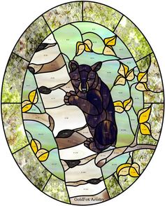 a bear sitting on top of a tree branch in front of a stained glass window