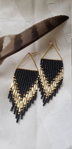 The romance between black and gold is timeless. Sparkling gold bugle beads shine brightly against a semi matte black backdrop. Pops of matte gold flank their boldness. Woven onto gold plated triangles and finished with 14k gold filled ear wires. Made to order. Gold Beaded Earrings With Dangling Beads For Evening, Handmade Gold Beaded Earrings For Evening, Elegant Black Beaded Earrings With Gold Beads, Gold Beaded Earrings With Black Beads For Party, Gold Dangle Earrings With Black Beads, Diy Earrings Materials, Western Fashion Jewelry, Handwoven Earrings, Earrings Classic