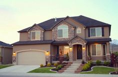 a large house with two garages in front of it