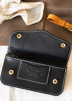 Our Brigg Leather Supply x Iron & Resin Roper Wallet is built for a lifetime of use. Made with a snap closure, a card slot, and a large zip pouch this wallet is ready for it all. Featuring a western inspired pattern and contrast stitching, this is a wallet that's not only functional but looks good doing it. THE SPECS + DETAILS 9-10oz USA Tanned Bridle Leather Traditional western wallet stylings One internal CC / ID slot Large zipper enclosed pouch Super durable nylon bonded threading with yo Roper Wallet, Leather Zip Pouch, Leather Supplies, Pouch Pattern, Leather Work, Zip Pouch, Digital Wallpaper, Leather Working, Leather Craft