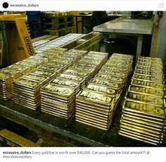 stacks of gold bars are stacked on top of each other in an assembly line at a factory