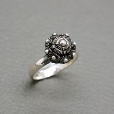 A dainty vintage sterling silver filigree ring, handcrafted in Holland around 1970's. The ring is made of a small antique dome shaped Dutch button, so called Zeeuwse Knoop. Such silver buttons were traditionally hand crafted in traditional Dutch filigree technique. Original piece of collectible Dutch heritage jewelry. The ring will be shipped in a gift box. Ring size: 3 3/4 (US) / H (UK) / diameter 14.6 mm/ European size 46 1/2 - it is really a small size ring Diameter of the Dutch button is abo Vintage Round Filigree Ring With Oxidized Finish, Vintage Adjustable Sterling Silver Rings, Vintage Nickel-free Sterling Silver Signet Ring, Vintage Sterling Silver Nickel-free Signet Ring, Antique Sterling Silver Adjustable Signet Ring, Vintage Nickel Free Sterling Silver Signet Ring, Vintage Oxidized Filigree Ring Gift, Nickel-free Vintage Sterling Silver Signet Ring, Victorian Sterling Silver Filigree Ring Stamped 925