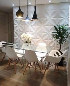 a glass dining table with white chairs around it