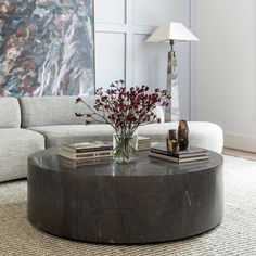 a living room with a large painting on the wall and a coffee table in front of it