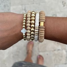 "The Woodlands Stack is a must have! It is a beautiful neutral collection that you will be able to combine with your existing bracelets for endless possibilities!  Makes a beautiful gift for holidays and birthdays! 🤍 The set of 5 contains: 1 - 8mm 14k gold plated ball bracelet (brushed gold) 1 - Telluride wooden disc bracelet 1 - Mother of Pearl quatrefoil and 14k gold plated hematite bracelet 1 - 8mm wooden bicone bead bracelet  1 - 8mm white \"luxe\" heishi bracelet with gold disc accents Bracelets are handmade on strong stretch cord and approximately 7 inches in length, which fits small to medium adult wrists. Custom sizing is available! If you have concerns about sizing, please message me so we can discuss the perfect fit your bracelets." Wood Bead Disc Bracelets, Beige Wooden Beads Bracelet As Gift, Beige Wooden Beads Bracelets As Gift, Everyday Beige Jewelry With Wooden Beads, Adjustable Gold Bracelets With Wooden Beads, Everyday Gold Stretch Bracelet With Wooden Beads, Gold Heishi Beads Jewelry With Wooden Beads, Gold Stacked Heishi Beads Jewelry, Gold Bead Bracelet Stack