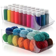 two acrylic containers filled with yarn and crochet hooks, each containing balls of thread