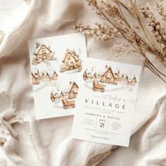 the wedding stationery is laid out next to some dried plants and flowers on a white sheet