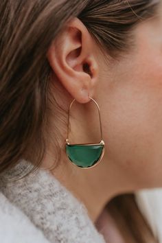 Close up view of model wearing the Without You Earrings which features gold oval shaped with a green stone. Green Teardrop Hoop Earrings For Everyday, Everyday Green Teardrop Hoop Earrings, Chic Green Earrings For Gift, Green Pierced Everyday Earrings, Green Pierced Earrings For Everyday, Modern Green Earrings For May Birthstone, Green Earrings For Everyday, Modern Green Oval Earrings, Modern Green May Birthstone Earrings