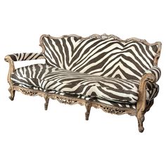 a zebra print couch sitting on top of a wooden frame