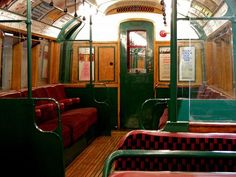 the inside of a train car with red and green seats