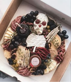 a box filled with different types of cheese and meats