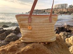 The season for Straw Beach Totes has started. If you're looking for a classic, yet stylish straw beach bag, the Paixao Fruit Straw Beach Bag is a great choice. The interior can zip shut and comes with a  small pocket purse for phones or keys. It has a chic interior lining that can pull upwards, making it easy to shake out any sand that gets in.   middle to big sized and available with rose and brown synthetic leather handles. 42 cm wide, 28 high. Brown Straw Bag For Daily Use And Vacation, Straw Bag For Daily Use And Vacation, Jute Bags For Daily Use And Vacation, Brown Crochet Bag For Travel And Vacation, Straw Bags For Daily Use On Vacation, Brown Crochet Travel Bag For Vacation, Daily Use Straw Bag For Vacation, Straw Shoulder Bag For Vacation Travel, Straw Shoulder Bag For Travel And Vacation