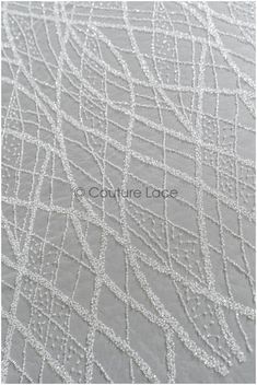 the texture of an upholstered fabric is shown in grey and white, as well as