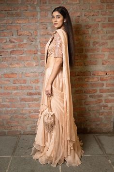 Beige pre-draped saree in a solid base with tiered layers and side drape. Comes with padded blouse embellished with 3D floral sequin and beads. - Aza Fashions Elegant Choli With Draped Sleeves And Traditional Drape, Bollywood Pre-draped Saree With Sheer Dupatta And Cape Sleeves, Traditional Lehenga With Draped Cape Sleeves, Elegant Draped Lehenga With Cutdana, Pre-draped Saree With Cape Sleeves For Reception, Elegant Draped Choli With Sheer Dupatta, Chanderi Lehenga With Traditional Drape For Evening, Evening Tissue Silk Sharara With Traditional Drape, Evening Chanderi Lehenga With Traditional Drape