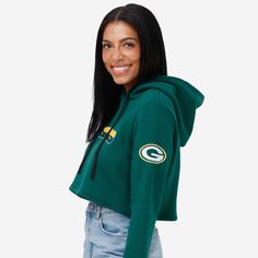 Stand out at the tailgate. Catch the eye of the jumbotron. Or just be the best-dressed fan in the crowd. Because the Green Bay Packers Women's Cropped Chenille Hoodie is here for you all gameday long. Features All-over, team-colored design so you can rep the team in style Bold team name display with chenille texture on chest, in case there were any doubts where your allegiances lie Team logo display with chenille texture on left sleeve for a little extra team spirit Team-colored stripe accent on Hooded Tops With Team Logo For Fans, Hooded Tops With Team Logo For Fan Gear, Hooded Tops For Fan Merchandise, Fan Merchandise Drawstring Hood Top, Team-colored Hooded Top For Fan Gear, Fan Merchandise Hooded Tops With Team Spirit, Game Day Fan Apparel Tops With Drawstring Hood, Collegiate Hooded Tops For Game Day, Team-colored Hooded Top For Game Day