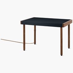 a table with a black top and wooden legs