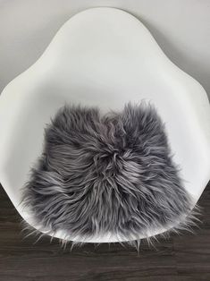 a white chair with grey fur on it