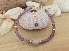 Length : 17,5 cm ---> 20 cm AAA+ micro faceted coffee moonstone focal : 11x8 mm Faceted natural amethyst : 4,5 mm 14K gold filled beads : 4x2 mm All components are 14K gold filled *What is gold filled ? Gold filled jewelry contains a  hundred times more gold than gold plated jewelry. That comes out to a 1/20 ratio.  Instead of having a tiny vulnerable layer of gold, gold filled is filled with layers of gold. The bottom layer is gold alloy, the middle layer is brass or sterling silver, and the to Designer Bracelet, Bracelets Design, Gold Alloys, Beautiful Coffee, Amethyst Bracelet, Jewelry Designer, Gold Filled Jewelry, Gold Plated Jewelry, Jewelry Plate