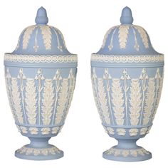 two blue and white vases sitting next to each other