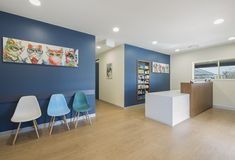 an office with blue walls and white chairs