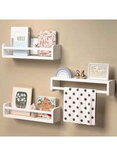 two white shelves with pictures and other items on them