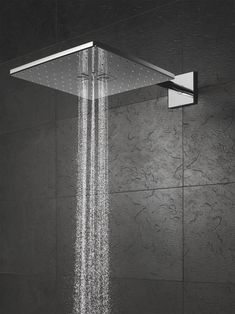 an overhead shower head with rain running down it