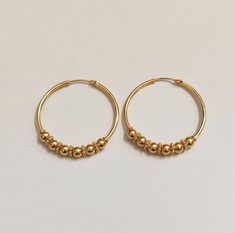 22k Hallmarked Gold Hoops, Indian Gold Hoops, Rajasthani Ball Hoops, Large Size Hoops, Classic Gold Hoops, Gold Earrings, Gold Jewelry Handmade Classic 22k Solid Gold Hoops Decorated with Tiny Multiple Balls, A forever design and a Classy look Gold Hoops for your Daily wear as well shine in your party. Metal: 22k Hallmark Gold ( tested in indian Lab) Size: 36mm Round Wire Goes in ear: 0.7mm (normal  piercing) Weight of Gold : 8 Gram nearly a oair Theme: Indian Rajasthani Hoops. We welcome custom Indian Hoop Earrings Gold, Gold 22k Jewelry, Earring Gold Hoop, Gold Earrings Designs Simple Daily Wear, Cheap Gold Chandbalis For Women, Daily Gold Jewelry, Simple Ear Rings Gold Daily Wear, Cheap Traditional Chandbalis For Women, 1 Gram Gold Earrings For Daily Use