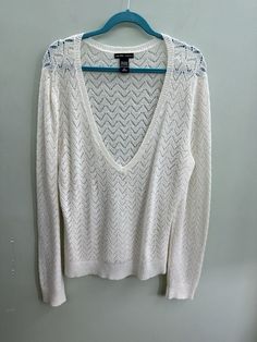 Elevate your wardrobe with this stunning white long sleeve deep V-neck woven acrylic sweater from NY&C. The classic cardigan style and solid pattern make it a versatile piece for any occasion. The lightweight and all-season features make it a must-have addition to your closet. Crafted with high-quality knit fabric, this sweater boasts a V-neckline that adds a touch of elegance to your outfit. The long sleeves provide warmth and comfort, making it perfect for chilly days. With its size L and regular size type, it's an ideal fit for any woman looking for a stylish and comfortable sweater. *disclaimer: all items come from a smoke-free, dog-friendly home.