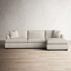 a white couch sitting on top of a hard wood floor