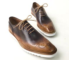 Buy TucciPolo Mens Exclusive Handmade Italian Leather two tone Brown Oxford Style Casual Sneaker Dress Shoes. This pair offers superior comfort and exquisite design. Its Elegant, classic, durable and very comfortable. Buy now with Affirm at checkout and pay in 3-12 months with no hidden fees. Leather : Hand polish Italian calf skin Leather Sole: Eva SoleColor: Two tone brown This is a made-to-order product. Each pair will be made upon receipt of order and shipped in approximately 15 days. Becaus Brown Low-top Dress Shoes With Contrast Sole, Designer Brown Plain Toe Oxfords, Designer Brown Wingtip Leather Shoes, Brown Leather Cap Toe Shoes With Contrast Sole, Brown Wingtip Sneakers With Contrast Sole, Brown Custom Wingtip Sneakers With Contrast Sole, Brown Slip-on Oxfords With Contrast Sole, Designer Brown Leather Shoes With Contrast Sole, Formal Brown Wingtip Custom Sneakers