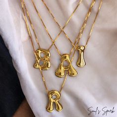 Elevate your summer style with our Bubble Letter Necklace, a stunning gold-plated monogram piece that combines fun and elegance. This balloon initial pendant is perfect for adding a personal touch to any outfit, whether you're hitting the beach or enjoying a night out. Crafted to be waterproof, this necklace is as durable as it is stylish, making it an ideal accessory for all your summer adventures. Unique Design: Features a charming bubble letter pendant that adds a playful yet sophisticated touch to your look. Gold Plated: Made with high-quality gold plating, ensuring durability and a brilliant shine that lasts. Waterproof: Designed to withstand summer activities, from beach days to pool parties, without losing its luster. Perfect Gift for Her: Whether it's for a birthday, anniversary, g Trendy Gold Name Necklace For Personalized Gift, Trendy Gold Necklaces For Personalized Gift, Customized Trendy Gold Necklaces, Gold Monogram Necklace In Trendy Style, Trendy Customized Gold Necklaces, Trendy Customizable Gold Necklaces, Trendy Gold Monogram Necklace, Trendy Personalized Gold Initial Necklace, Gold Trendy Initial Necklace