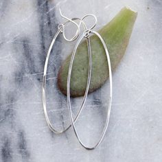 These minimalist hammered wire earrings have a graceful long ellipse shape that traces the curve of your neck. They are striking, yet simple, and can easily transition from day to night. They are big enough to make a bold statement, but still light and understated enough to wear all the time. Approximately 2 inches long. Available in sterling silver or 14k gold fill. All Rebecca Haas Jewelry is handcrafted by me in my Southern Vermont Studio from recycled and ethically sourced materials. Nickel Free Oval Minimalist Earrings, Nickel-free Oval Minimalist Earrings, Minimalist Sterling Silver Oval Hoop Earrings, Minimalist Nickel-free Oval Earrings, Minimalist Oval Everyday Earrings, Simple Oval Everyday Jewelry, Simple Everyday Oval Jewelry, Minimalist Handmade Oblong Jewelry, Everyday Oval Jewelry With Ear Wire