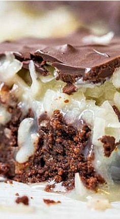 a close up of a piece of cake with ice cream and chocolate on it,