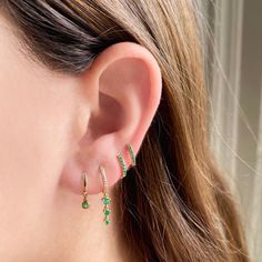 Crafted with gorgeous green Emeralds, these Mini Huggies add the perfect pop of color to any ear story. Available in 14k Yellow Gold Each earring features 7 Emeralds totaling .04 carats 10mm Diameter Sold Individually or as a Pair Green Prong Setting Earrings In Fine Jewelry Style, Elegant Green Huggie Jewelry, Green Huggie Fine Jewelry Earrings, Green Fine Jewelry Huggie Earrings For Gift, Green Huggie Earrings Fine Jewelry, Green Diamond Pierced Earrings, Green Diamond Drop Earrings With Prong Setting, Green Gemstone Huggie Earrings, Green Huggie Earrings With Matching Set