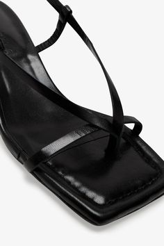 Strappy sophistication. Our Greta Sandals feature a modern square toe and an adjustable slingback strap for a flattering look, enhanced by a chic kitten heel and minimalist raw edges. Whether it's running between meetings or dancing the night away, their padded soles and soft Italian leather let you do it all in comfort—and impeccable style.[SPLIT] Astrid wears Greta in black, in cream, and in disco. Heel height is approximately 2" (5 cm). Sold in US sizes, though please note that shoes may be l Trendy Evening Sandals With Straps, Summer Open Toe Slingback Pumps With Straps, Sleek Slingback Sandals With Wrapped Heel, Sleek Slingback Pumps With Square Toe, Sleek Ankle Strap Sandals, Evening Kitten Heels With Penny Strap And Open Heel, Evening Slingback Kitten Heels With Heel Loop, Evening Open Heel Kitten Heels With Penny Strap, Summer Evening Slingback Sandals With Straps