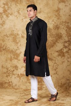 Bluesaanchi Mirror Magic Black Men's Kurta Set  The Bluesaanchi Mirror Magic Black Men's Kurta Set is a stylish and elegant addition to any man's wardrobe. Crafted with precision and designed for comfort, this kurta set is perfect for festive occasions, weddings, or casual gatherings. The intricate mirror work adds a touch of sophistication, making it a standout piece. Pair it with traditional footwear for a complete look.  Key Features  Elegant black color with intricate mirror work.  Comfortable fit with breathable fabric.  Ideal for festive occasions and casual gatherings.  Comes with matching bottoms for a complete look.   Specifications  Product Type: Kurta Set  Brand: Bluesaanchi  Color: Black  Size Range: Available in multiple sizes   Material & Care  Material: High-quality cotton f Elegant Eid Kurta For Puja, Designer Wear Kurta With Traditional Fit For Transitional Season, Semi-stitched Elegant Kurta For Puja, Elegant Semi-stitched Kurta For Puja, Black Naqshi Kurta For Festivals, Black Churidar For Eid, Formal Cotton Kurta For Festivals, Formal Festival Cotton Kurta, Black Naqshi Straight Kurta Traditional Wear