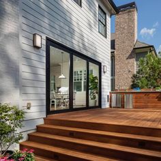 a wooden deck with steps leading up to a house