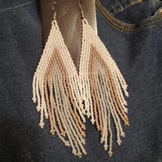 These handmade, bohemian vintage braided beaded tassel earrings are perfect for adding a unique touch to any outfit. Made from high-quality beads and durable copper ear needles for a comfortable fit. Designed in a vintage, boho style, suitable for daily wear and festival celebrations, including Mardi Gras. Every pair is handcrafted, making each one one-of-a-kind with slight variations. Bohemian Brown Tassel Earrings For Summer, Brown Bohemian Tassel Earrings For Summer, Bohemian Long Drop Tassel Earrings, Beige Bohemian Fringe Earrings, Summer Brown Tassel Jewelry, Bohemian Long Drop Chandelier Earrings With Tassels, Bohemian Chandelier Earrings With Tassels, Bohemian Long Drop Earrings For Summer, Beaded Fringe Dangle Tassel Earrings For Festival