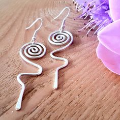 A large pair of spiral lightening dangle drop earrings, made with thick silver wire. Wire wrapped jewellery that makes great gifts for wives or girlfriends with a bohemian style, funky festival jewellery or a unique birthday gift. 💝 These earrings have been hand shaped in thick 1.5mm silver wire into hoops with spirals, they have then been hammered slightly flat.  💝 They can be made in either silver plated (nickel and lead free with an anti tarnish finish) or 925 sterling silver. Use the varia Modern Twist Spiral Wrap Earrings, Modern Twist Spiral Wrap Earrings As Gift, Modern Twist Swirl Earrings For Gifts, Modern Twist Dangle Jewelry For Gifts, Silver Wrap Earrings With Modern Twist As A Gift, Modern Twist Silver Wrap Earrings As Gift, Swirl-shaped Pierced Earrings For Gift, Swirl Shaped Pierced Jewelry Gift, Modern Twist Dangle Earrings As Gift