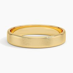 a yellow gold wedding ring on a white background