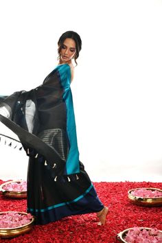 Crafted with care and expertise, this Handwoven Pure black Soft cotton by Kora Banarasi saree offers a unique look. Boasting a striking blue mashru silk border and a luxurious black color, this saree exudes a classy, elegant feel. Experience elegance and comfort like never before. Black Cotton Silk Pre-draped Saree For Diwali, Black Handloom Pre-draped Saree For Festivals, Black Silk Saree With Zari Work, Black Silk Pre-draped Saree With Sheer Dupatta, Black Silk Dupatta With Traditional Drape, Elegant Black Chanderi Saree, Black Silk Saree For Festive Occasions, Festive Black Silk Saree, Black Tussar Silk Traditional Wear For Designer Occasions