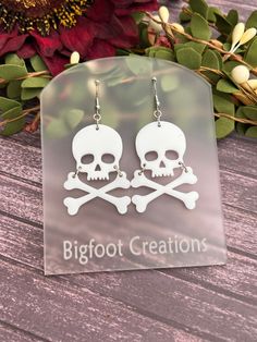 Channel your inner pirate or add a touch of gothic flair with these bold skull and crossbones earrings! Crafted from high-quality acrylic, these earrings feature a striking skull and crossbones design that's perfect for making a statement. Whether you're celebrating Halloween or simply love edgy accessories, these earrings will add a daring touch to any outfit. Lightweight and comfortable to wear, these earrings are an ideal choice for anyone who enjoys unique and standout jewelry. They also mak Gothic Skull Earrings For Halloween, Halloween Skull Print Skull Earrings, White Gothic Handmade Earrings, Handmade White Gothic Earrings, Gothic Skull Print Earrings For Gift, Gothic Skull Print Earrings As Gift, Gothic White Dangle Jewelry, White Gothic Dangle Jewelry, White Gothic Skull Jewelry