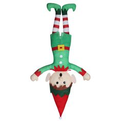 an elf doll hanging upside down from the ceiling with his head in a christmas hat