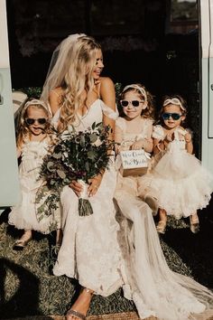 the bride and her flower girls are all dressed up