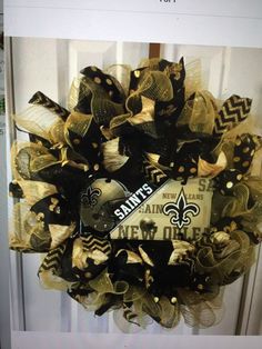 a new orleans saints wreath hanging on the front door