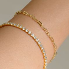 Our Paperclip bracelet is a golden staple to wear alone or stack with our other gold filled bracelets. Our 14k gold-filled jewelry is bonded with 14k gold and is water and tarnish resistant. 14k gold-filled jewelry is a great alternative to solid gold, and can be worn by people with sensitive skin. The color will not tarnish but recommend to keep away from perfumes and lotions. - 14k gold-filled- Chain width: 3.5 mm.- Chain length: 6"- Water resistant / Tarnish resistant / Hypoallergenic Everyday Gold Plated Tennis Bracelet, Dainty 14k Gold Tennis Bracelet For Everyday Wear, Dainty 14k Gold Tennis Bracelet, Tarnish Resistant, Everyday Gold Tarnish Resistant Tennis Bracelet, Everyday Gold Tarnish-resistant Tennis Bracelet, Gold Minimalist Tennis Bracelet With Adjustable Chain, Minimalist Gold Tennis Bracelet With Adjustable Chain, Minimalist Gold Tennis Bracelet For Everyday, Classic Gold Plated Bracelets With Paperclip Chain